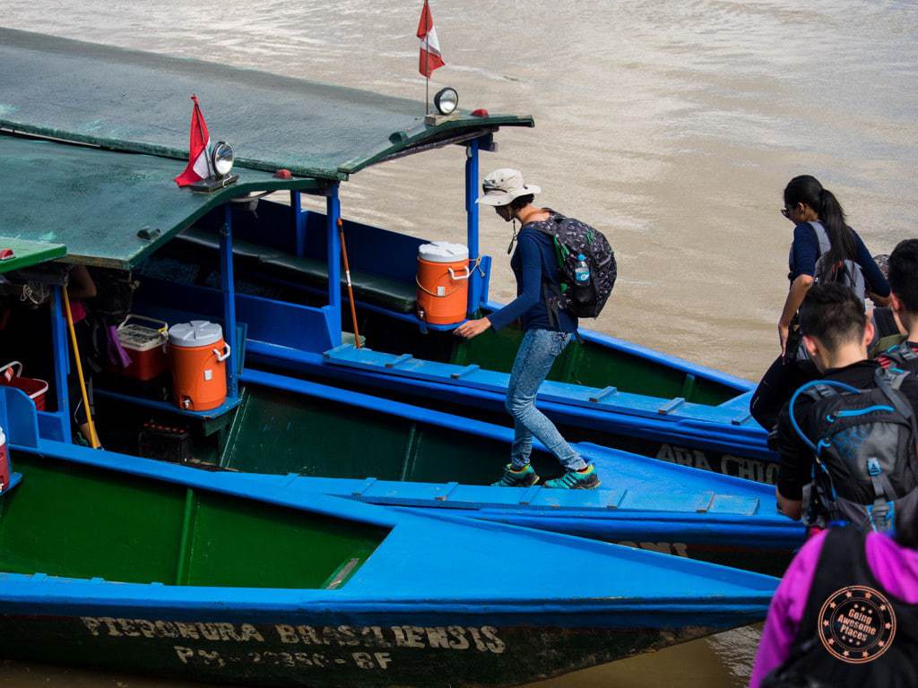 Boarding boat on Tambopata River in Peru Amazon planning guide to Refugio Amazonas