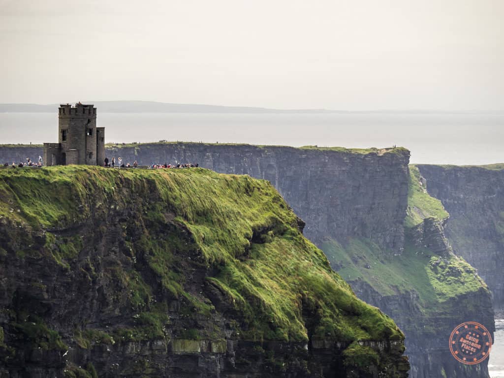 The huge crowds of tourists by the tower at Cliffs of Moher