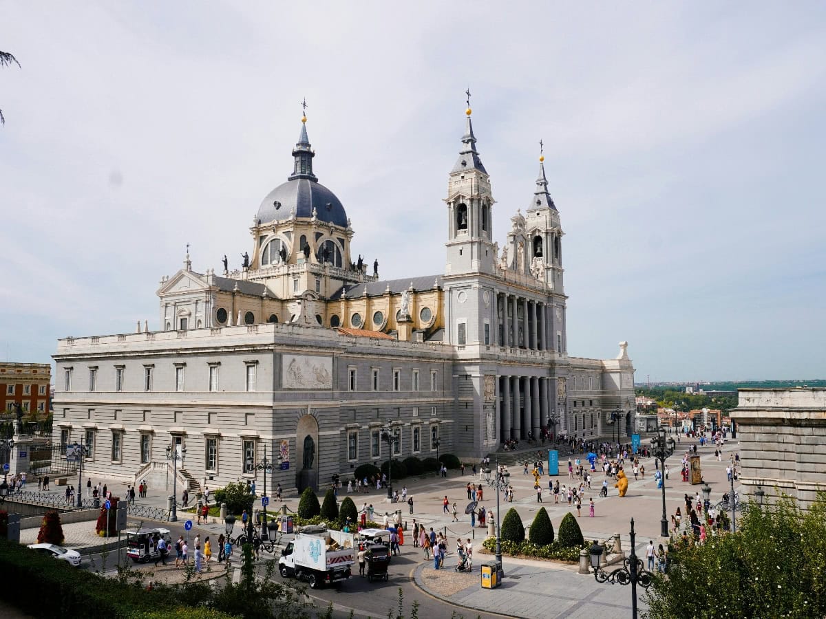 view of crowd in front of almudena cathedral from afar