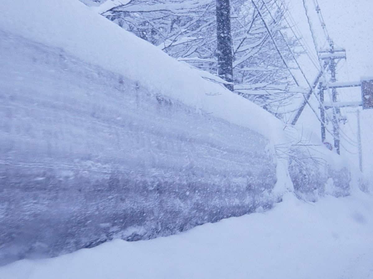 snow and ice wall on the side of street in aomori