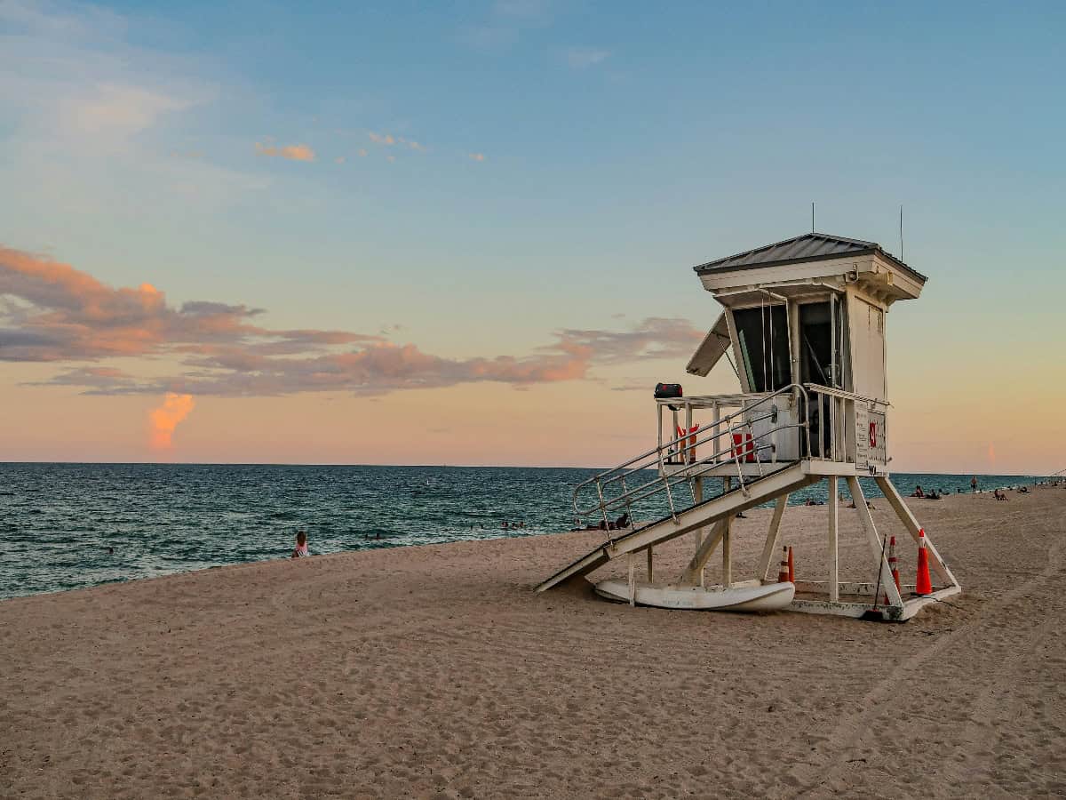 lifeguard hut sitting on beach in fort lauderdale at sunset