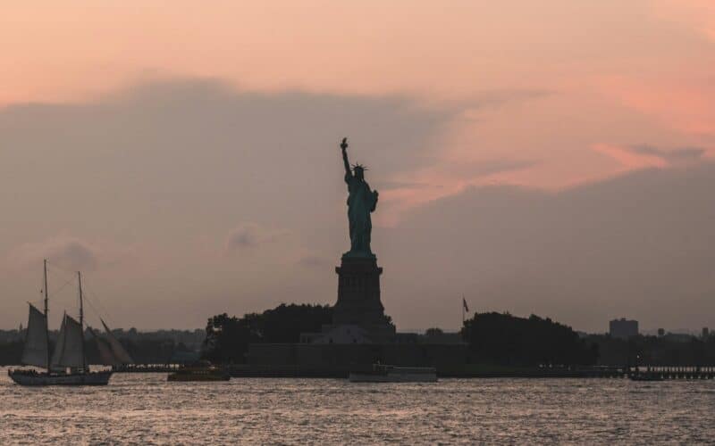 sunset view of statue of liberty on ellis island