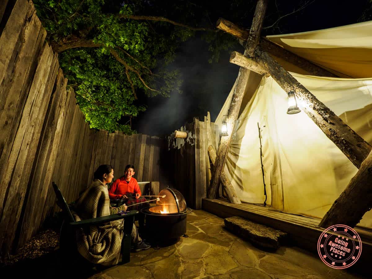 camp long creek glamping unit with fire pit and couple making s'mores