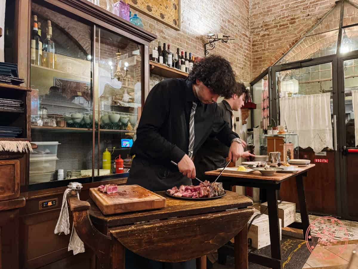 carving bistecca alla fiorentina at taverna di san giuseppe