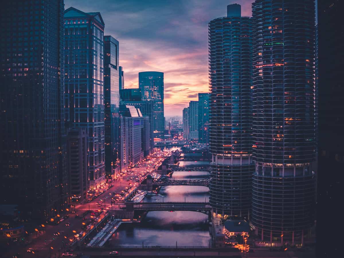 rooftop view of busy chicago street next to river in the center of buildings