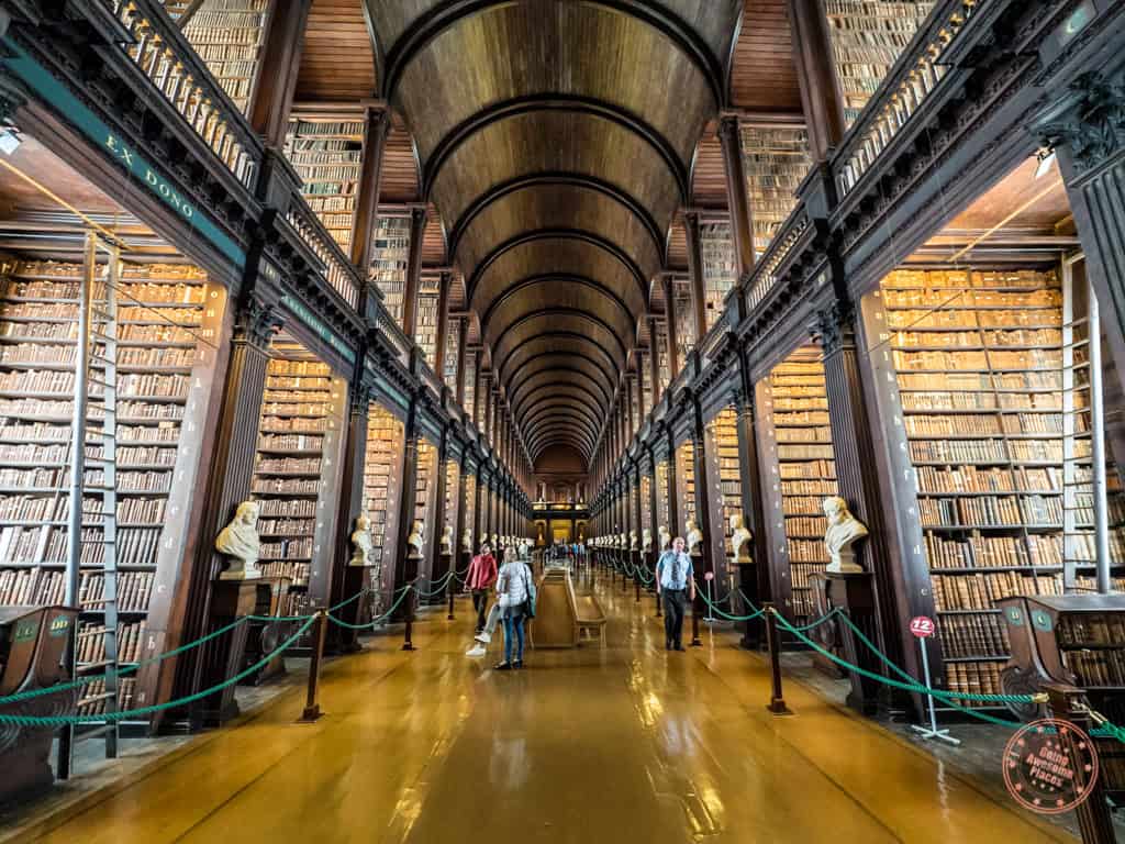 hall between bookshelves in library of trinity college