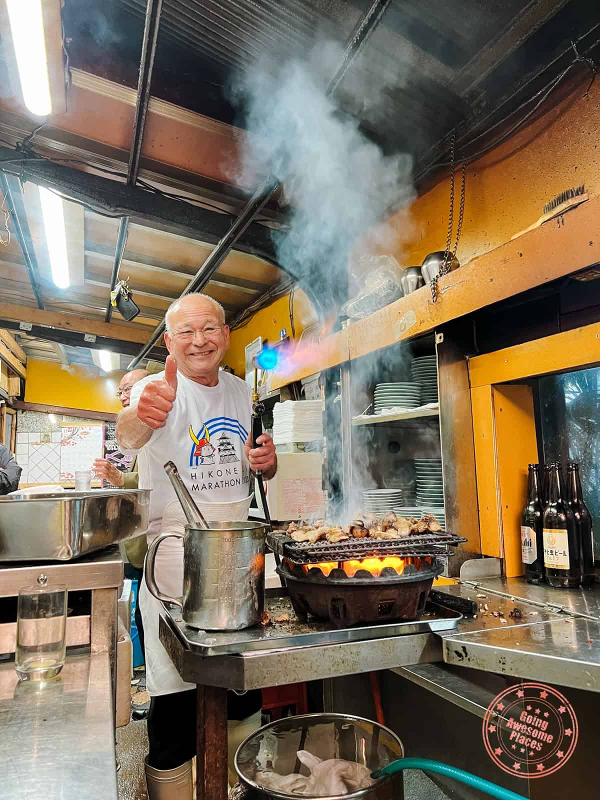 izakaya toyo thumbs up pose cooking tuna cheeks