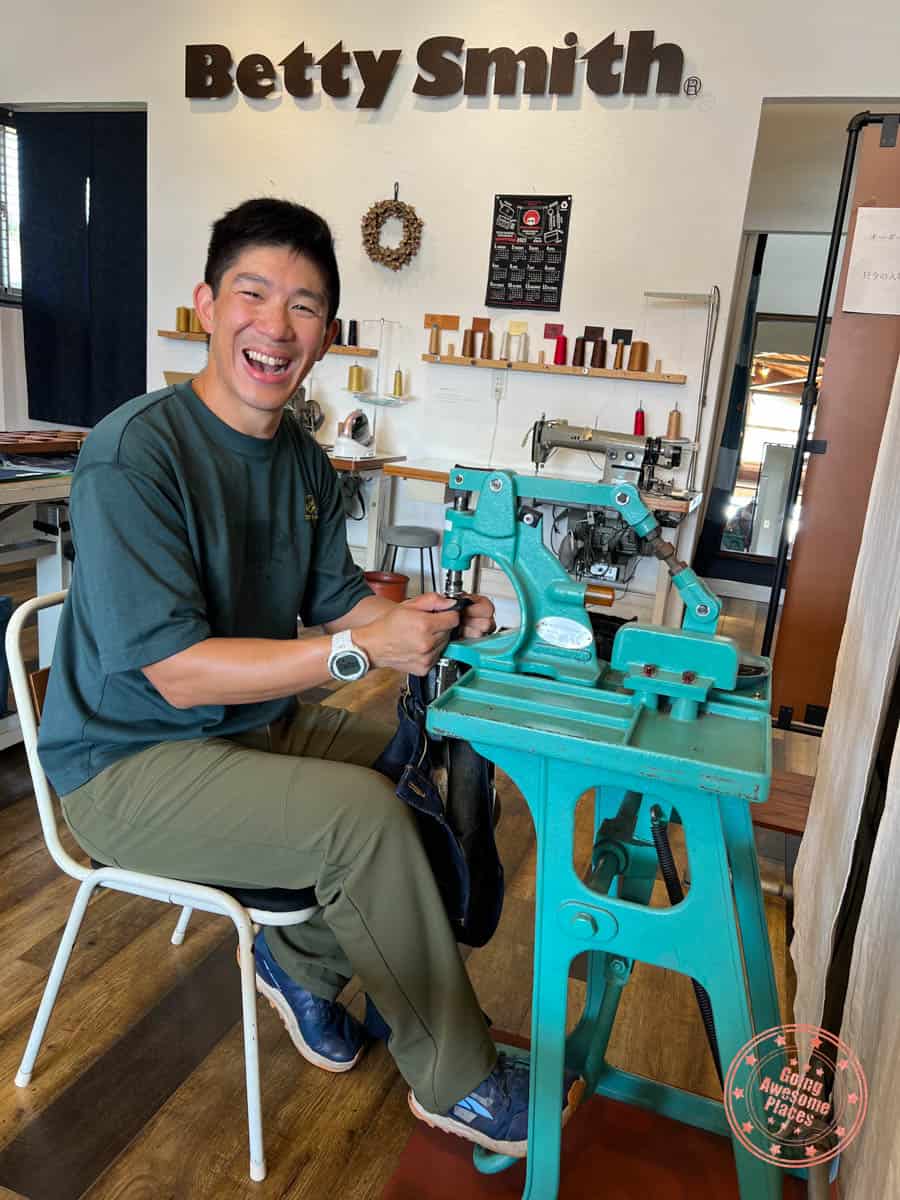 man at the rivet stamping machine at kojima betty smith jeans making experience