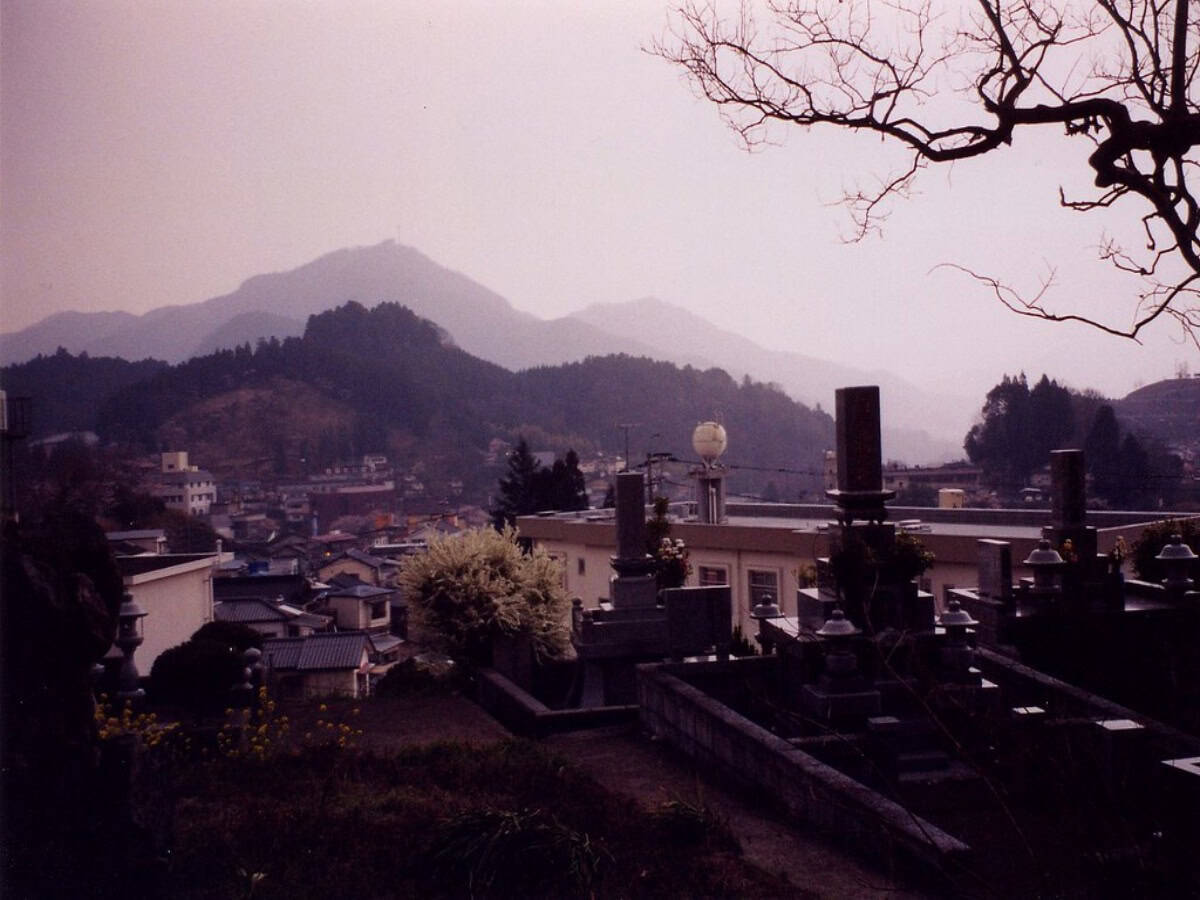 overlook of a foggy town before mountain range in kyushu