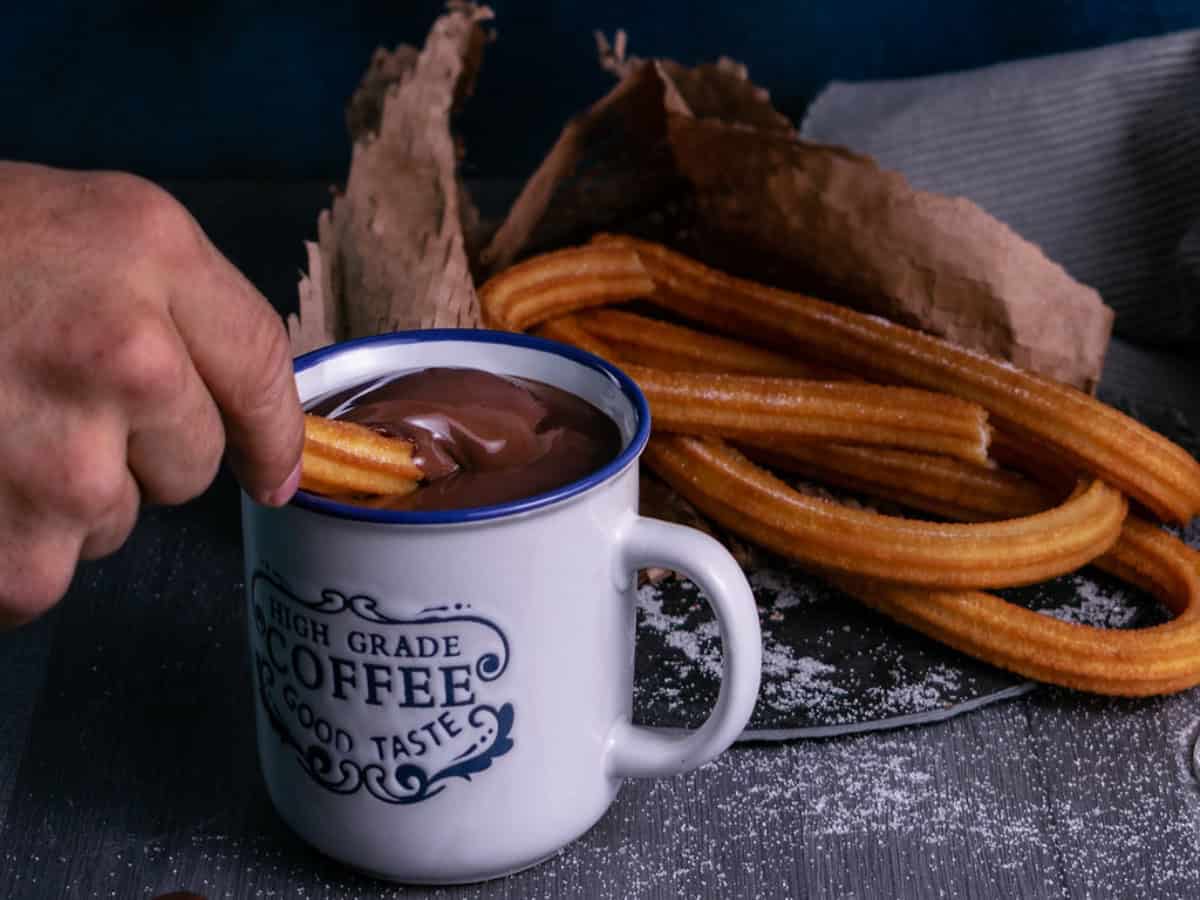 dipping churros in thick hot chocolate