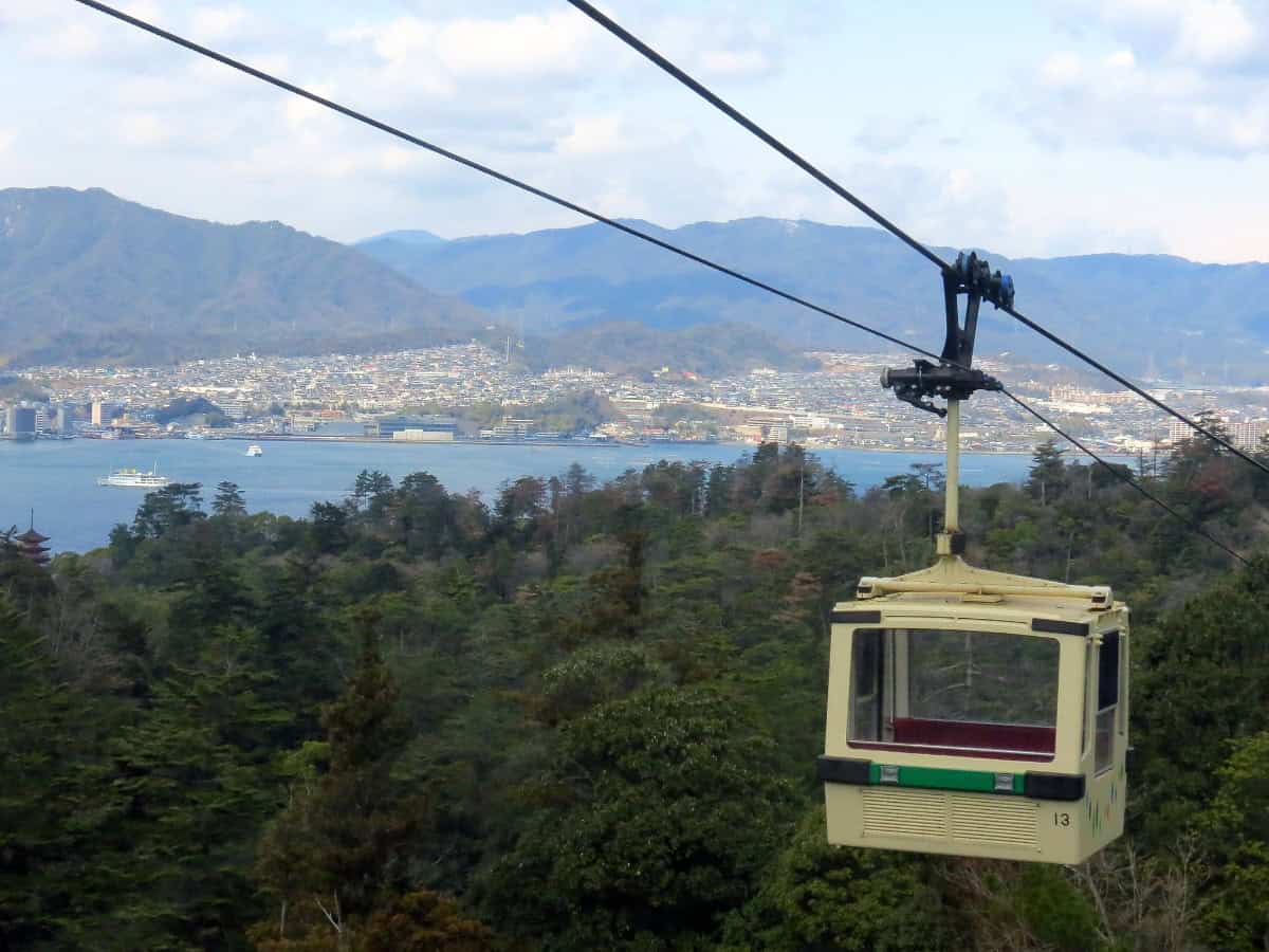 cart hanging from miyajima ropeway with beautiful views in the distance