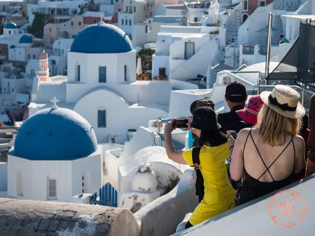 crazy line ups to take photos of the blue churches in oia