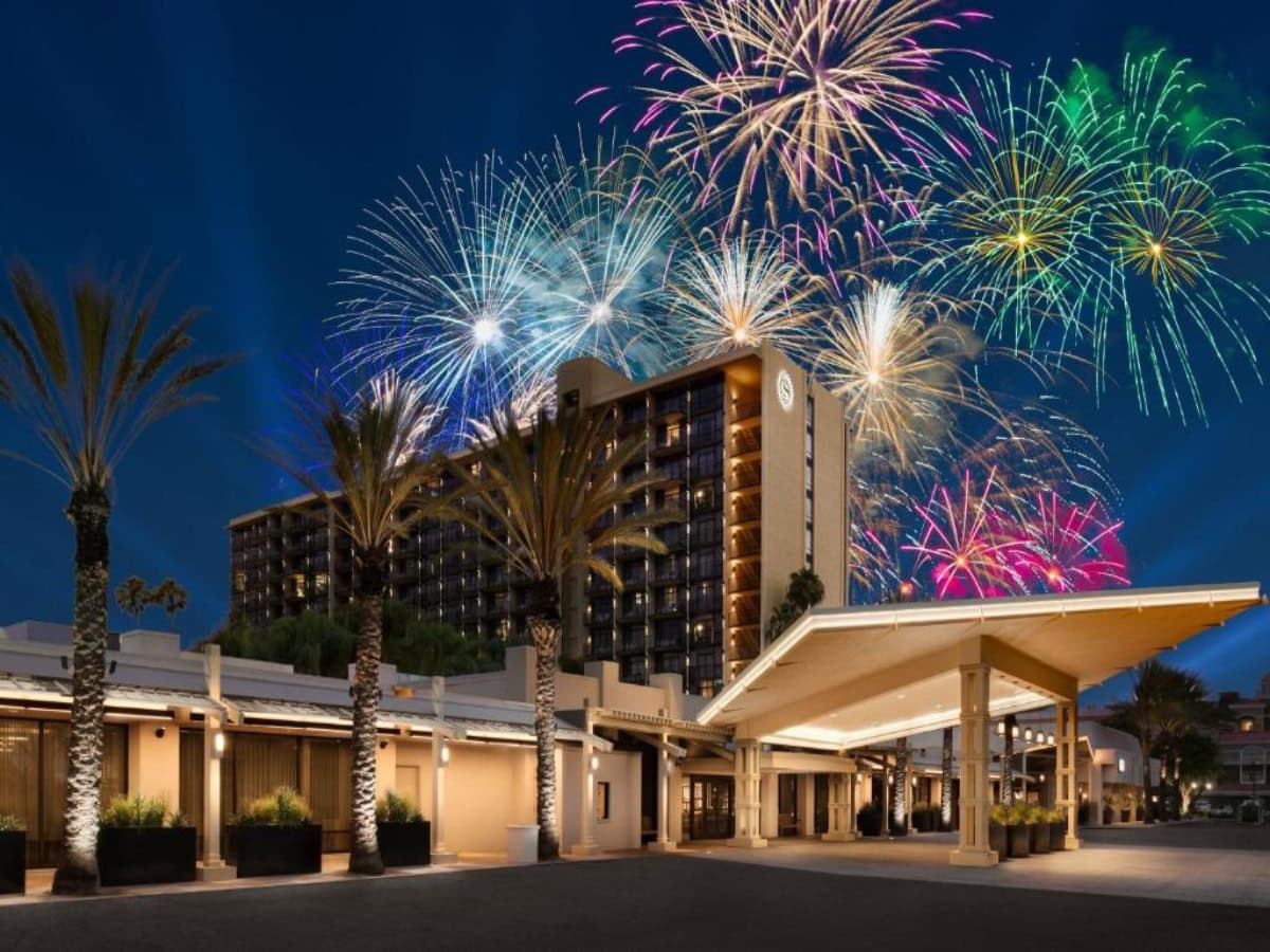 fireworks going off behind sheraton park hotel at the anaheim resort
