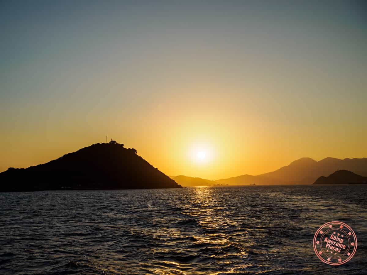 sunset and mountain silhouette on ferry from peng chau to hong kong central pier