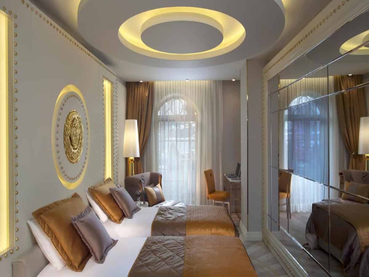 sura design hotel and suites opulent bedroom with two queen beds