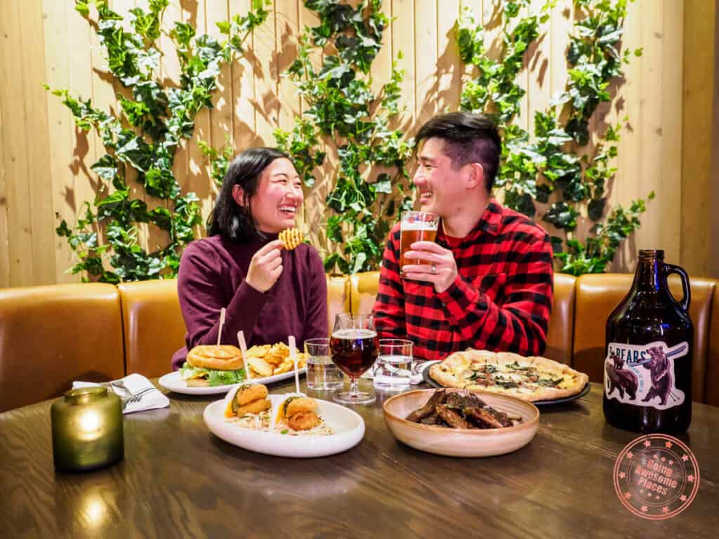 three bears brewery and restaurant banff with asian couple eating