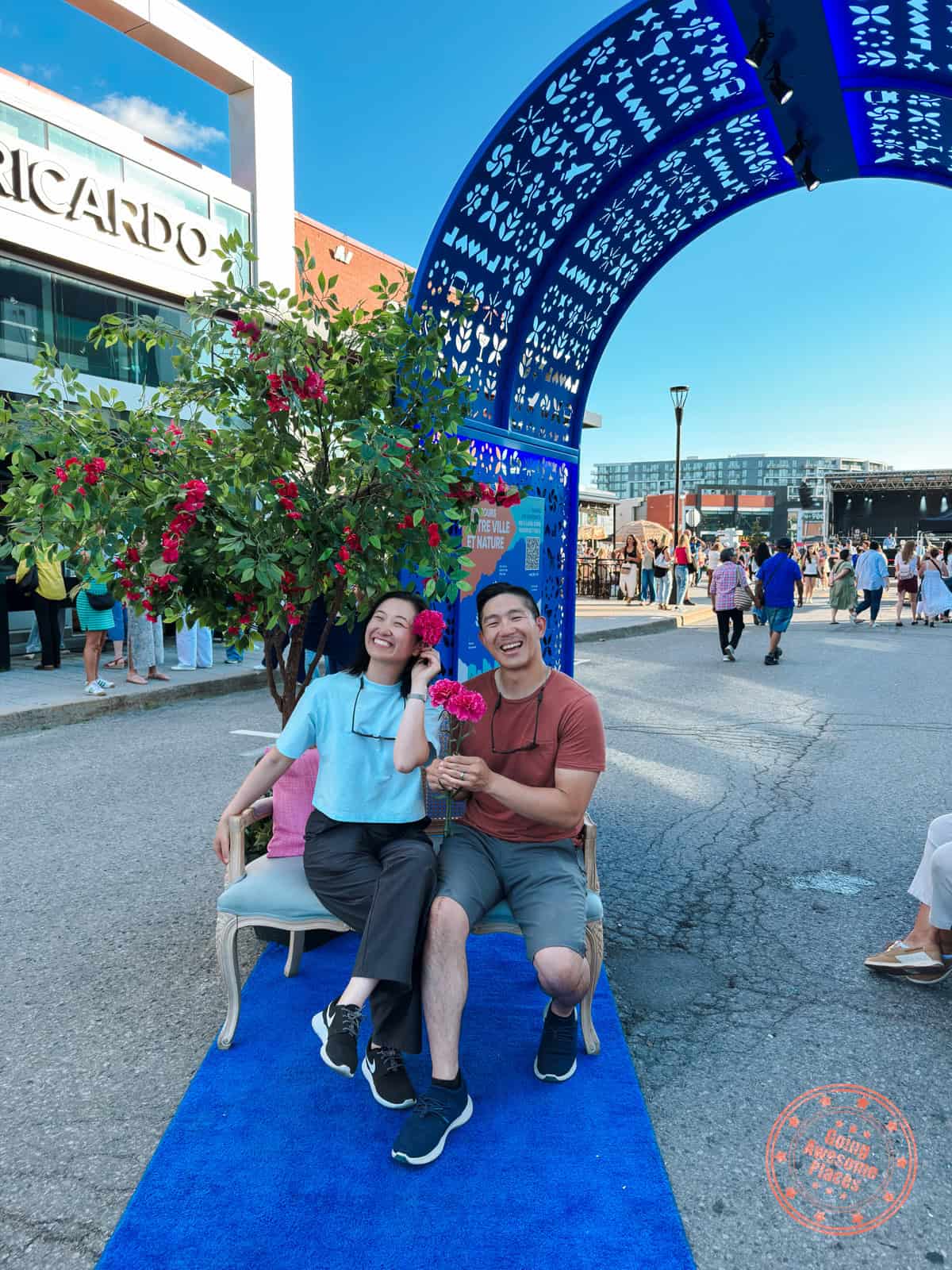 couple taking a photo at the tourisme laval booth at centropolis