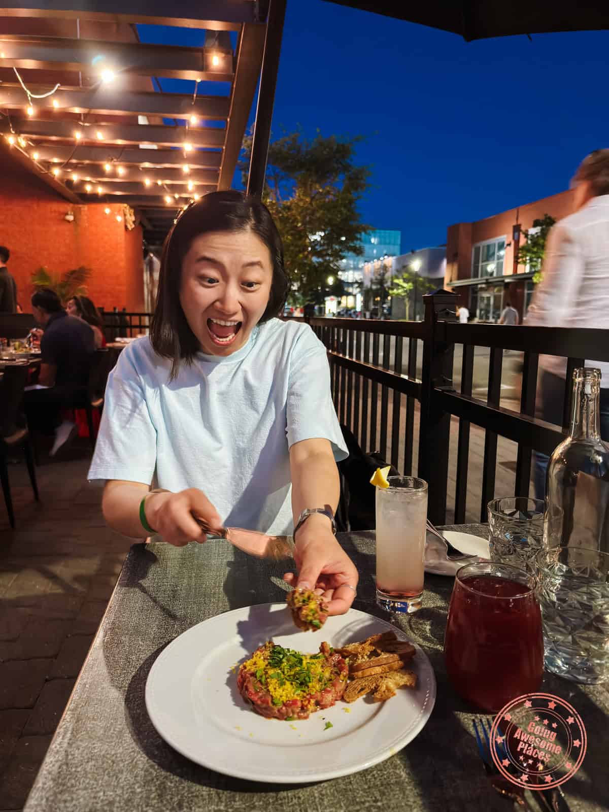 woman enjoying beef tartare at les enfants terribles
